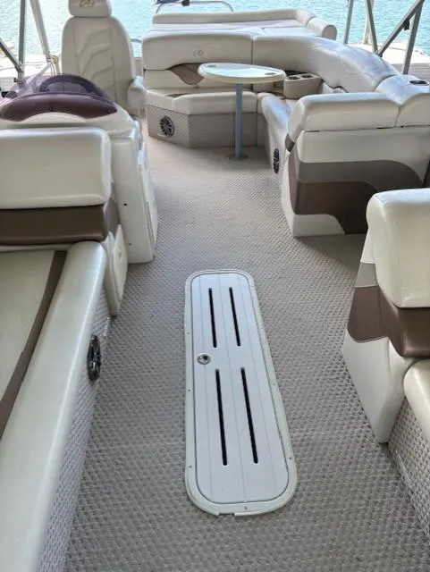 Slide: The Image of 2007 Avalon Windjammer RC 22' boat interior with plush seating and table. - 5