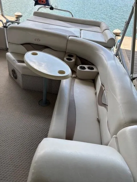 Slide: The Image of Luxurious seating on 2007 Avalon Windjammer RC 22' pontoon boat with table and cup holders. - 6