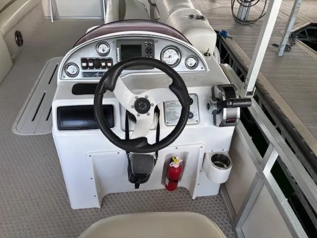 Slide: The Image of 2007 Avalon Windjammer RC boat dashboard with steering wheel and control panel. - 9