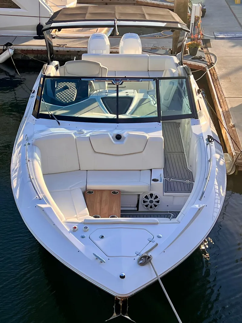 Slide: The Image of 2020 Cruisers Yachts 338OB boat docked, featuring sleek design and spacious seating. - 5