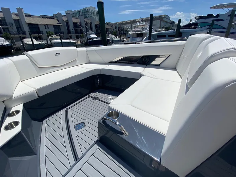 Slide: The Image of 2020 Cruisers Yachts 338OB boat interior with white seating and modern design. - 7