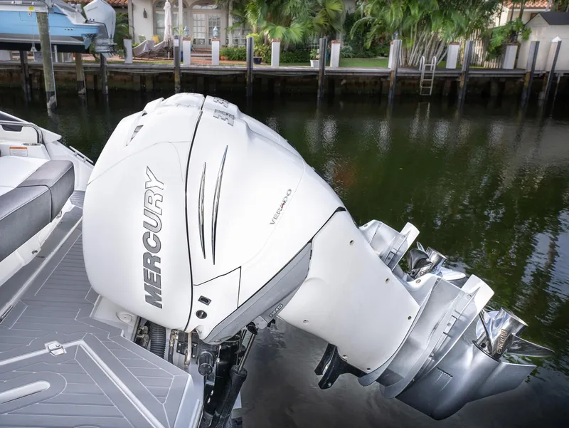 Slide: The Image of 2020 Cruisers Yachts 338OB with Mercury outboard engine, docked by waterfront. - 9
