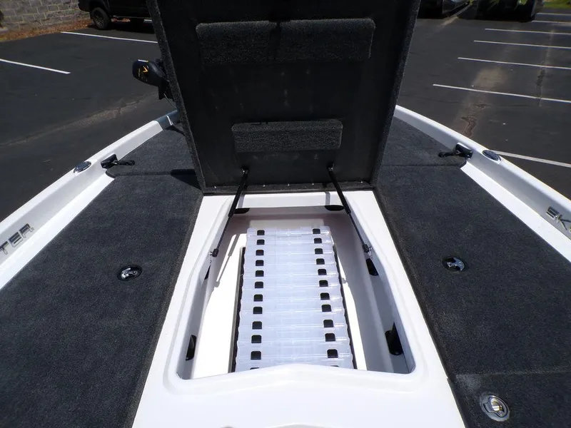 Slide: The Image of Open storage compartment on 2025 Skeeter ZXR19 boat, showing interior details. - 12