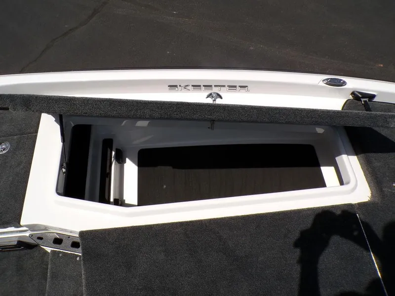 Slide: The Image of Open storage compartment on a 2025 Skeeter ZXR19 boat deck. - 13