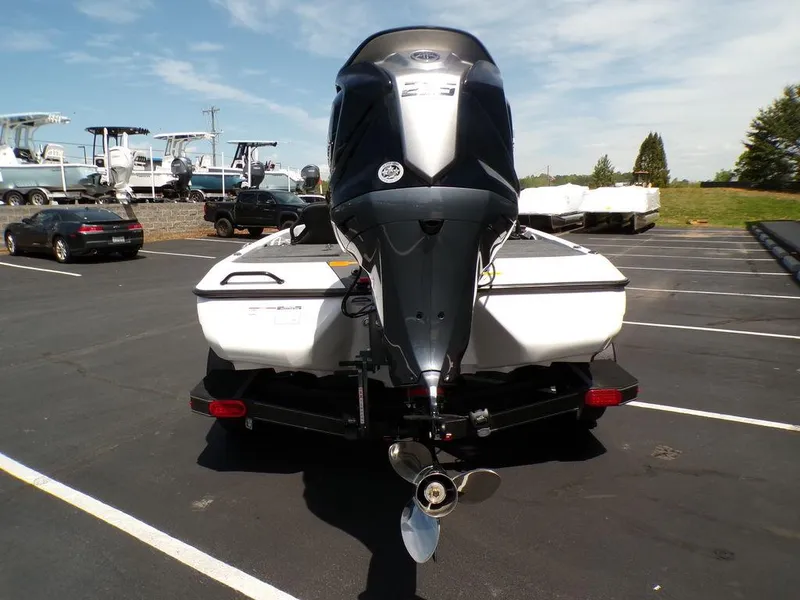 Slide: The Image of Rear view of a 2025 Skeeter ZXR19 boat with an outboard motor in a parking lot. - 21