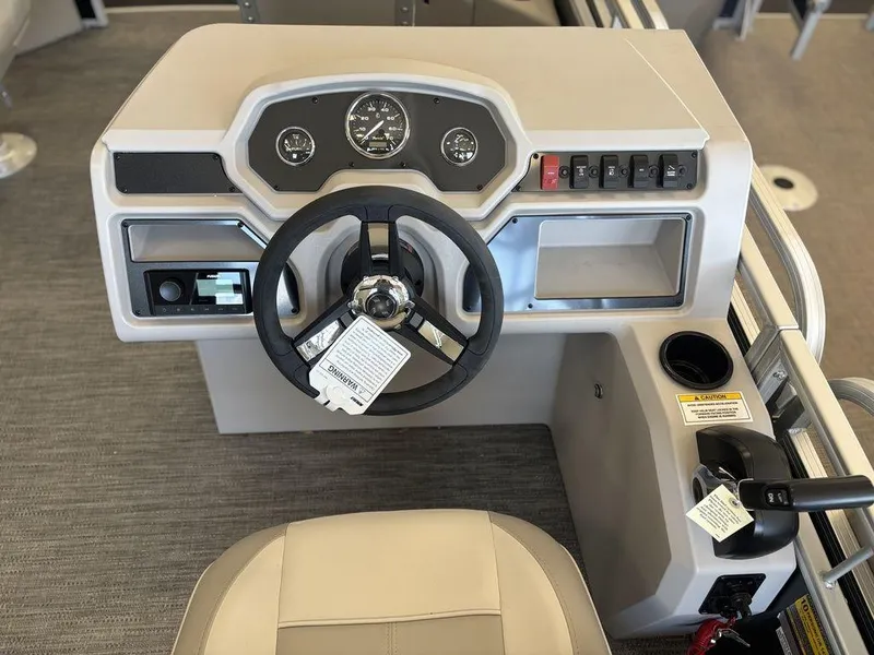 Slide: The Image of 2025 Godfrey Xperience 1886 FX boat dashboard with steering wheel and control panel. - 13