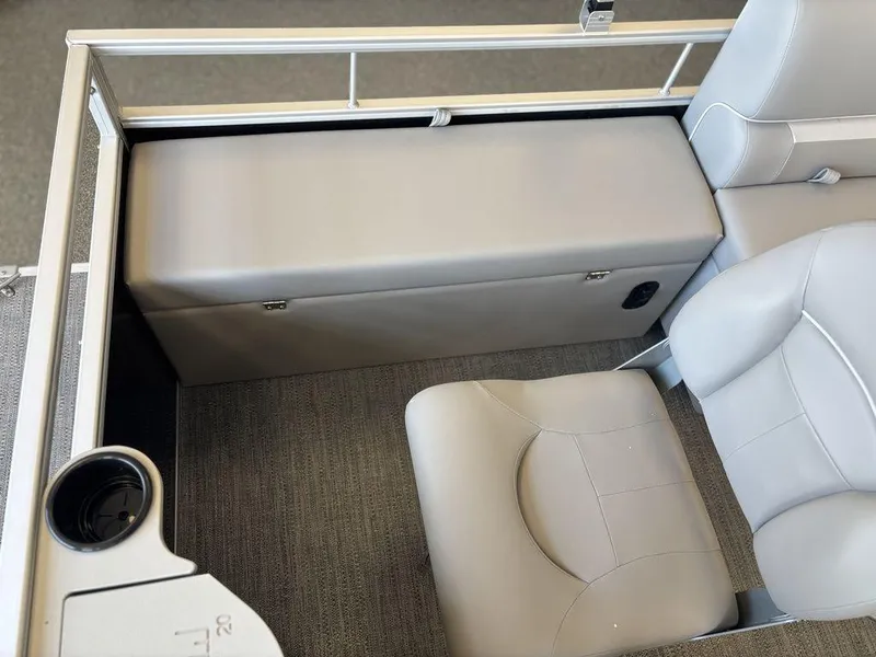 Slide: The Image of Interior seating of 2025 Godfrey Xperience 1886 FX boat, featuring gray upholstery and cup holder. - 18