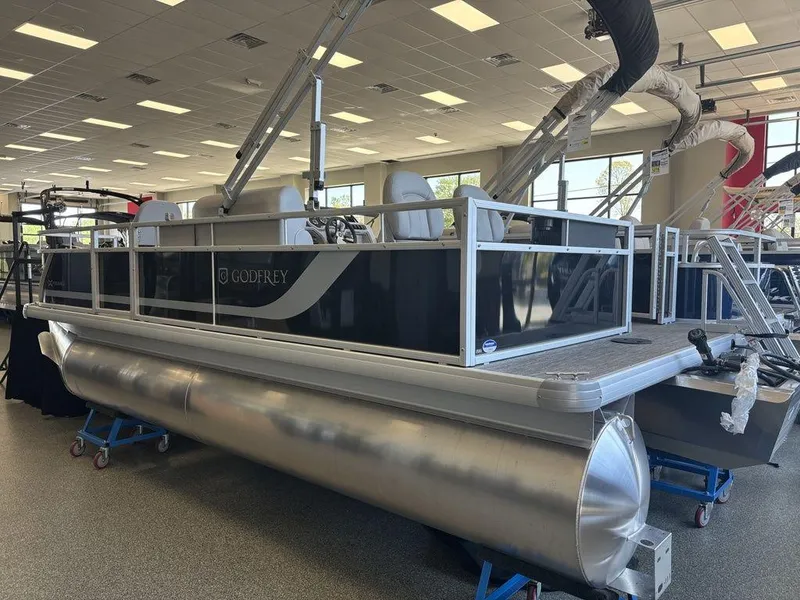 Slide: The Image of 2025 Godfrey Xperience 1886 FX pontoon boat displayed indoors. - 2