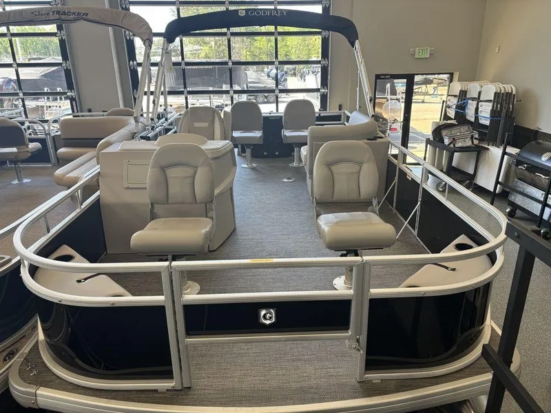 Slide: The Image of 2025 Godfrey Xperience 1886 FX pontoon boat with seating, displayed indoors. - 4
