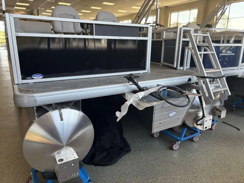 Slide: The Image of 2025 Godfrey Xperience 1886 FX pontoon boat in showroom, rear view with ladder. - 5