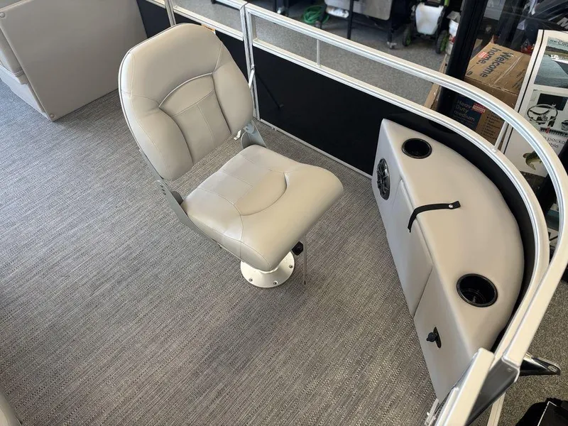 Slide: The Image of 2025 Godfrey Xperience 1886 FX boat interior with a swivel captain's chair and control panel. - 6