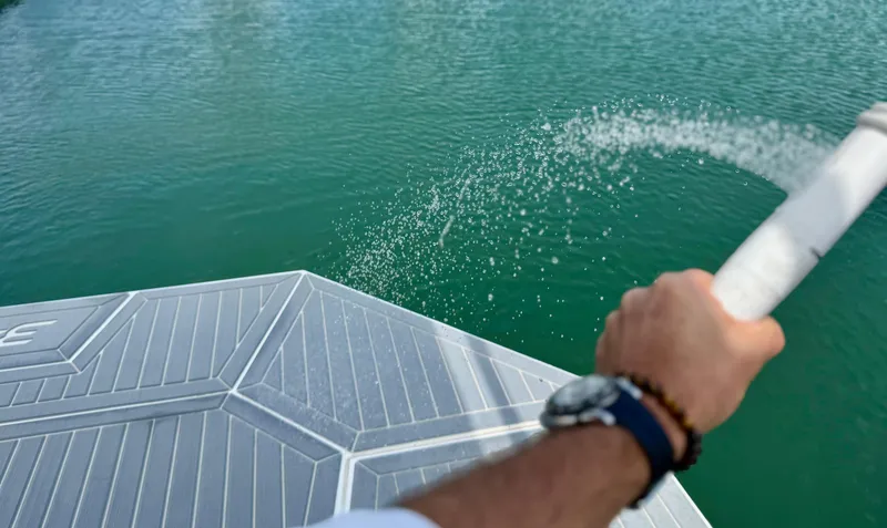 Slide: The Image of Man spraying water from 2023 Cruisers Yachts 34 GLS I/O into the sea. - 16