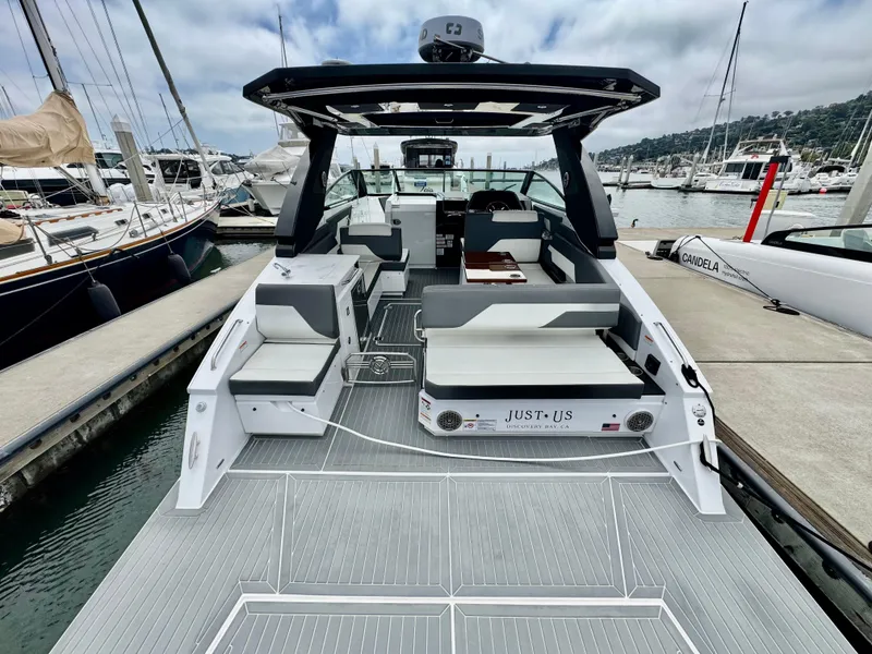 Slide: The Image of 2023 Cruisers Yachts 34 GLS I/O luxury boat docked at marina, showcasing spacious deck. - 17