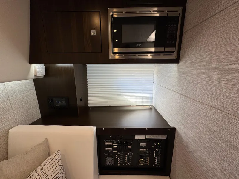 Slide: The Image of 2023 Cruisers Yachts 34 GLS I/O interior with microwave and control panel. - 55