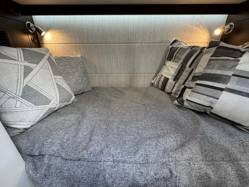 Slide: The Image of 2023 Cruisers Yachts 34 GLS I/O cabin with cozy bedding and modern lighting. - 59