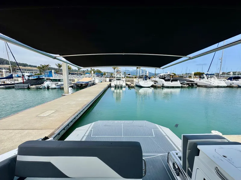 Slide: The Image of 2023 Cruisers Yachts 34 GLS I/O at marina, view from deck under canopy. - 11