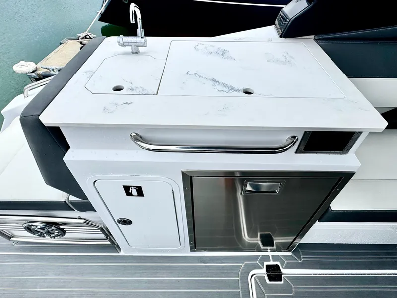Slide: The Image of 2023 Cruisers Yachts 34 GLS I/O boat kitchenette with sink and storage. - 16