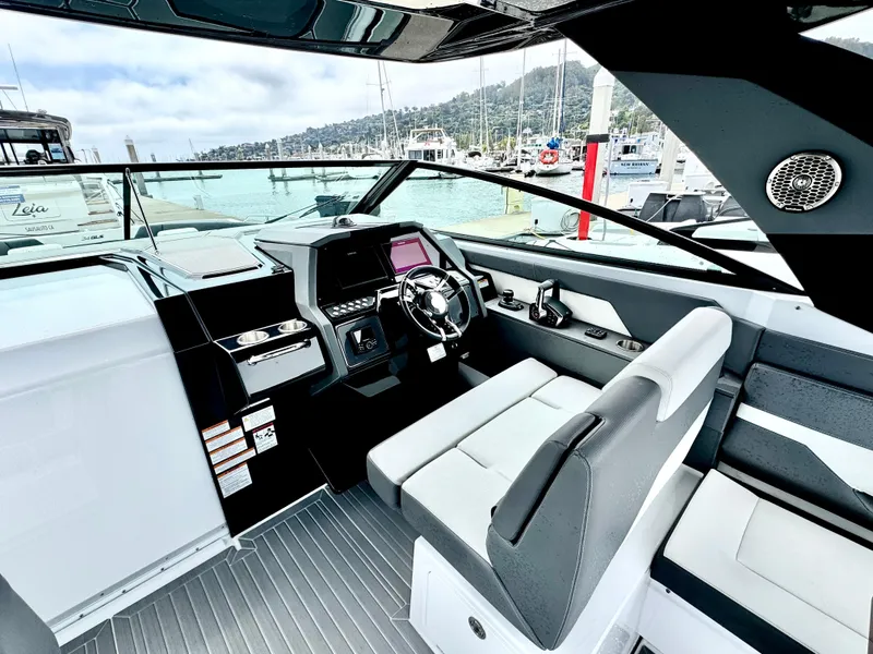 Slide: The Image of 2023 Cruisers Yachts 34 GLS I/O cockpit with modern controls and waterfront view. - 23