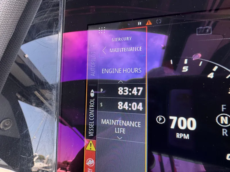 Slide: The Image of 2023 Cruisers Yachts 34 GLS I/O dashboard displaying engine hours and RPM. - 26