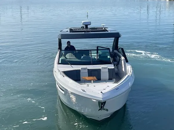 Slide: The Image of 2023 Cruisers Yachts 34 GLS I/O on calm water, front view. - 3