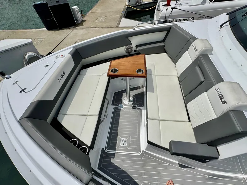 Slide: The Image of 2023 Cruisers Yachts 34 GLS I/O boat interior with seating and table, docked at marina. - 39