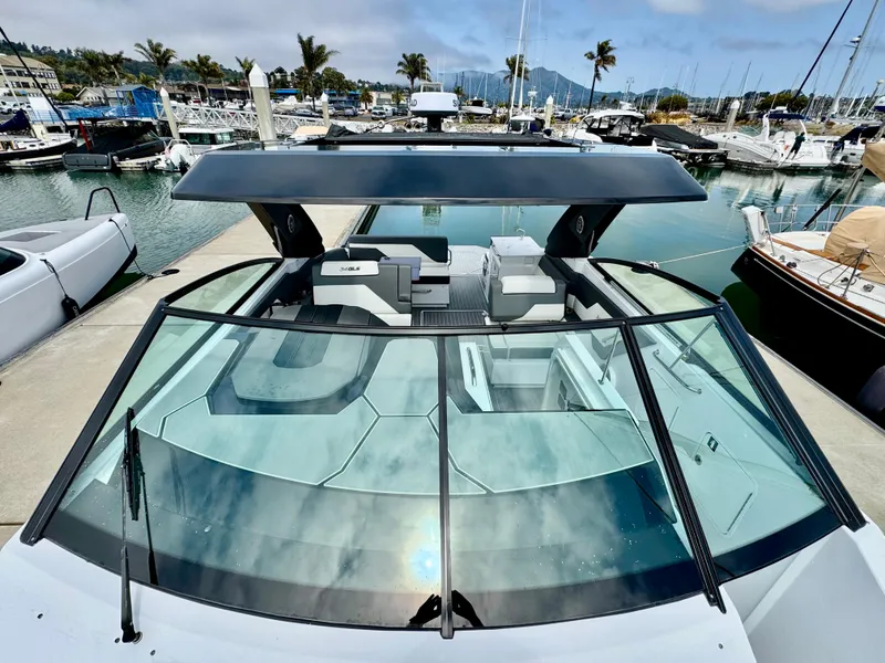 Slide: The Image of 2023 Cruisers Yachts 34 GLS I/O at marina, showcasing sleek design and spacious deck. - 42