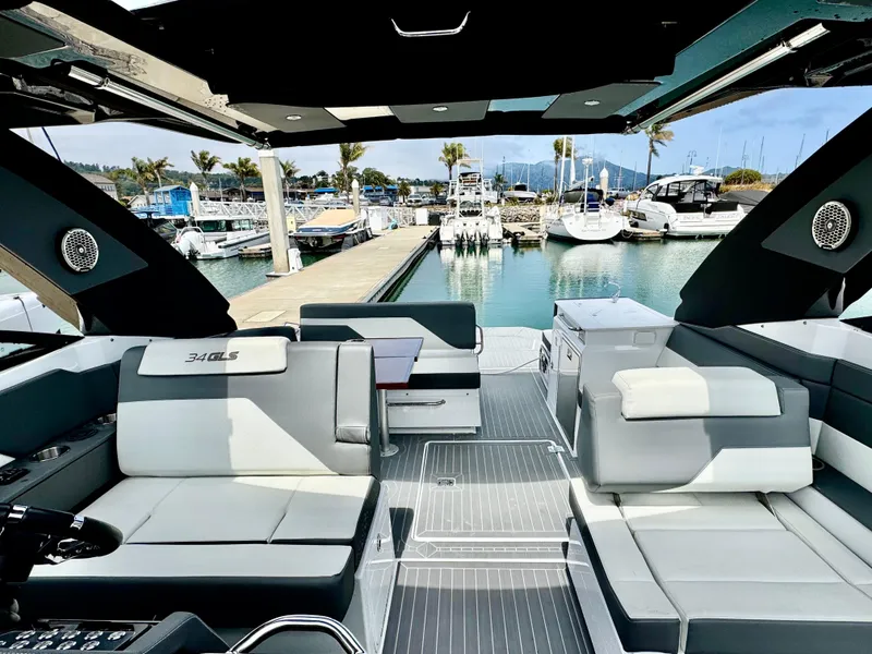 Slide: The Image of 2023 Cruisers Yachts 34 GLS I/O interior at marina, showcasing luxury seating and modern design. - 43