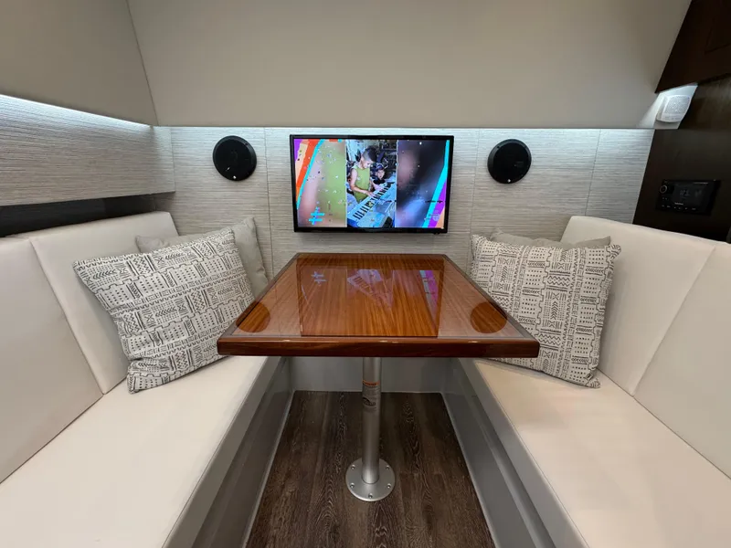 Slide: The Image of 2023 Cruisers Yachts 34 GLS I/O interior with cozy seating and entertainment system. - 50