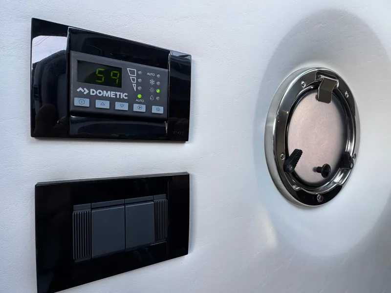 Slide: The Image of Control panel and porthole on 2023 Cruisers Yachts 34 GLS I/O boat. - 53