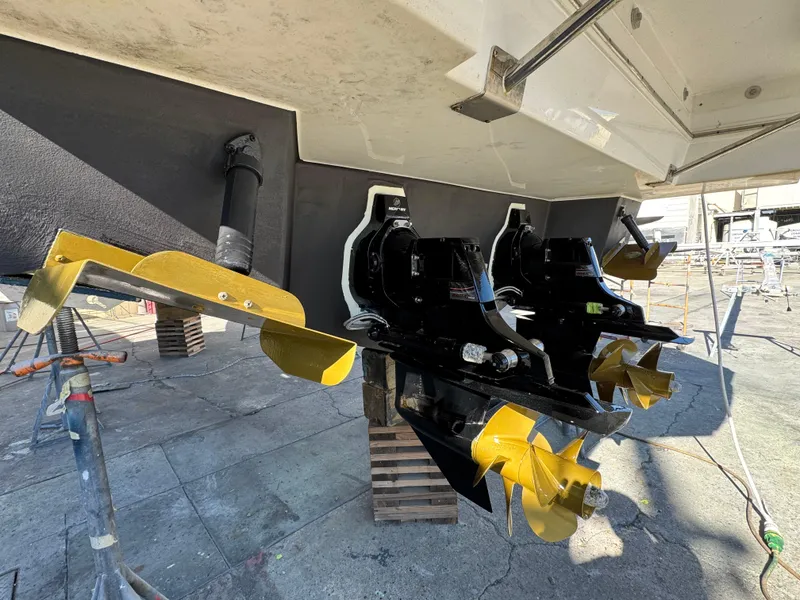 Slide: The Image of 2023 Cruisers Yachts 34 GLS I/O with dual propellers in a shipyard setting. - 65