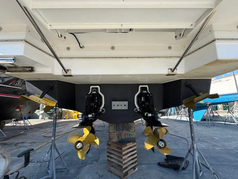 Slide: The Image of 2023 Cruisers Yachts 34 GLS I/O boat with dual propellers on display in a marina. - 66