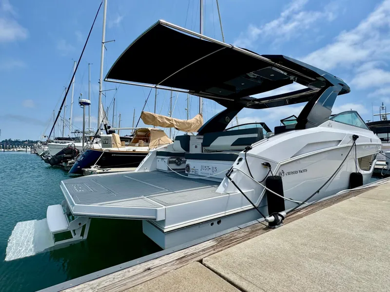 Slide: The Image of 2023 Cruisers Yachts 34 GLS I/O docked, showcasing sleek design and spacious deck. - 8