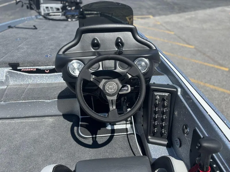 Slide: The Image of 2025 Phoenix 721 ZXL boat dashboard with steering wheel and control panel. - 14