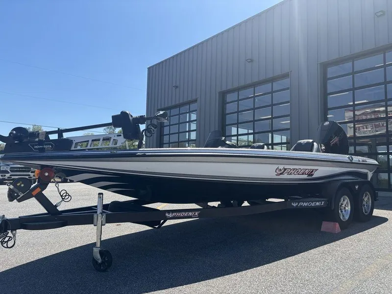 Slide: The Image of 2025 Phoenix 721 ZXL boat on trailer outside a modern building. - 7