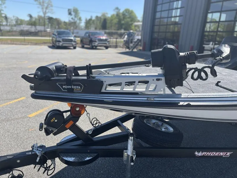 Slide: The Image of 2025 Phoenix 721 ZXL boat on trailer with Minn Kota trolling motor in parking lot. - 8
