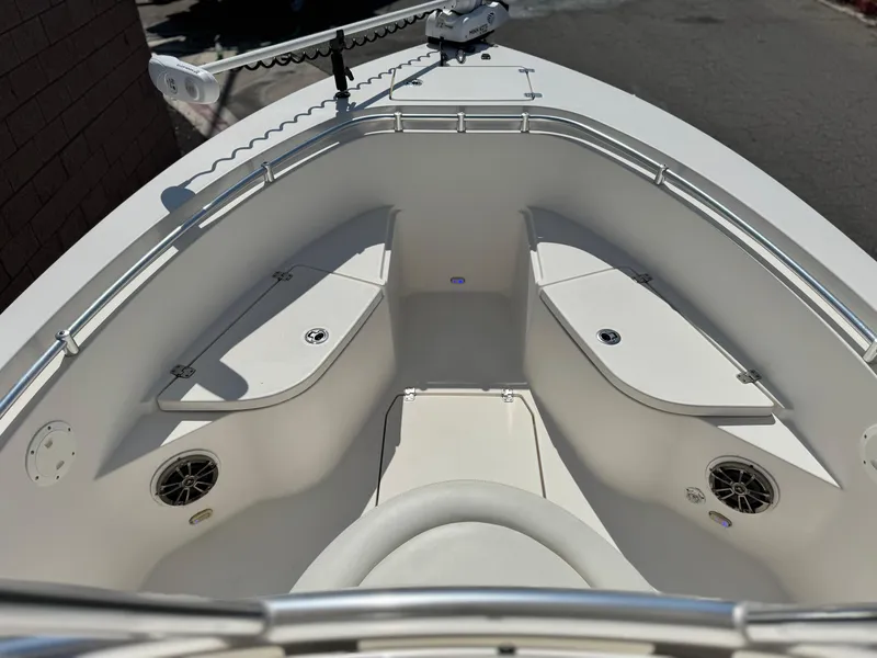 Slide: The Image of 2017 Cobia 237 Center Console boat interior with seating and storage compartments. - 12