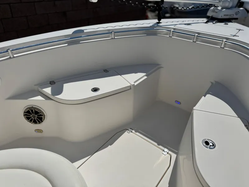 Slide: The Image of 2017 Cobia 237 Center Console boat interior with seating and storage compartments. - 13