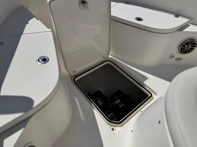 Slide: The Image of 2017 Cobia 237 Center Console boat storage compartment with open hatch. - 16