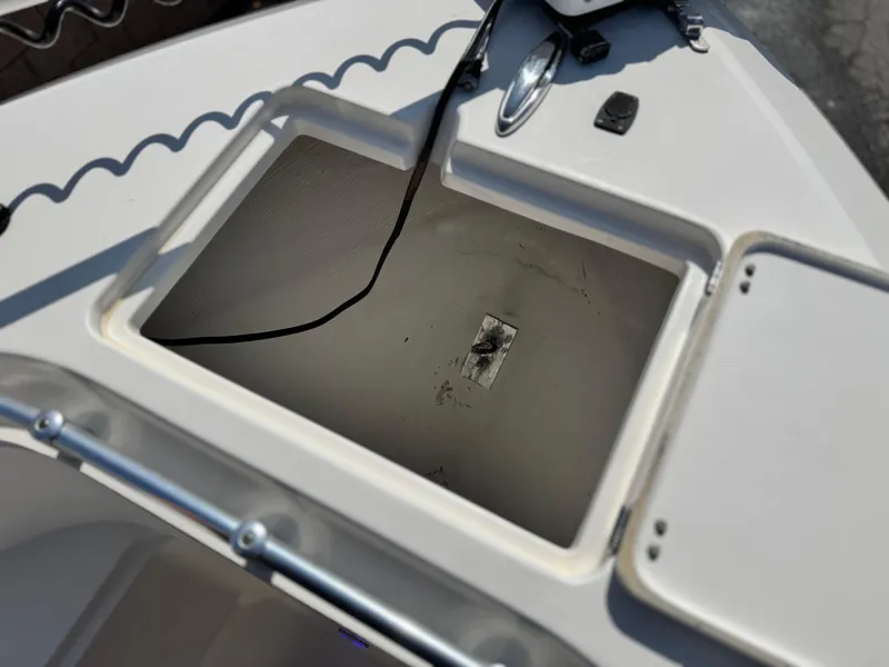 Slide: The Image of Open storage compartment on a 2017 Cobia 237 Center Console boat. - 18