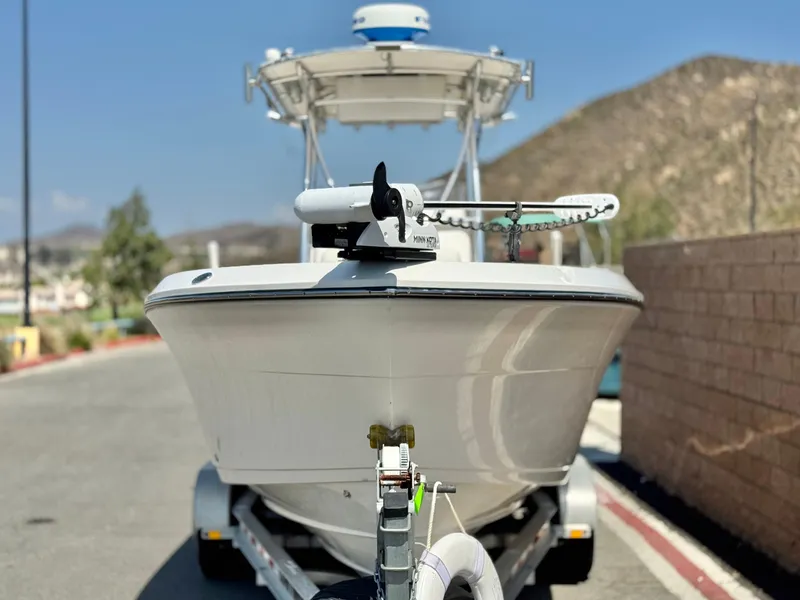 Slide: The Image of 2017 Cobia 237 Center Console boat on trailer, parked outdoors. - 2