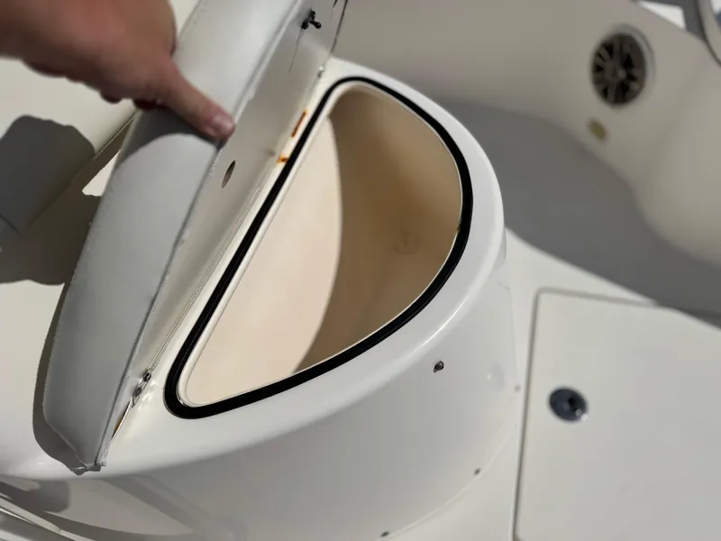 Slide: The Image of 2017 Cobia 237 Center Console boat storage compartment with open lid. - 24