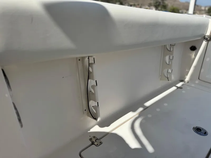 Slide: The Image of 2017 Cobia 237 Center Console boat interior detail with rod holders. - 27