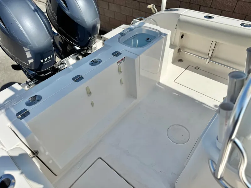 Slide: The Image of 2017 Cobia 237 Center Console boat with dual engines and spacious deck layout. - 29
