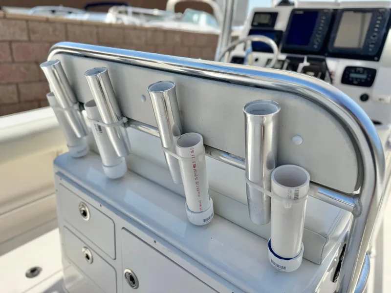 Slide: The Image of 2017 Cobia 237 Center Console boat with rod holders and control panel. - 34