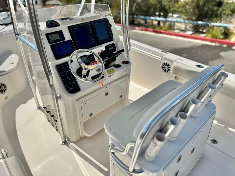 Slide: The Image of 2017 Cobia 237 Center Console boat interior with steering wheel and control panel. - 38