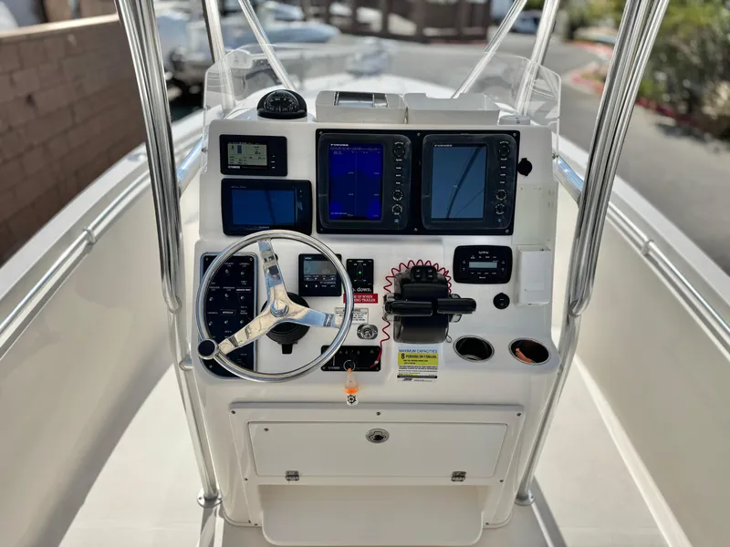 Slide: The Image of 2017 Cobia 237 Center Console boat dashboard with navigation and control systems. - 39