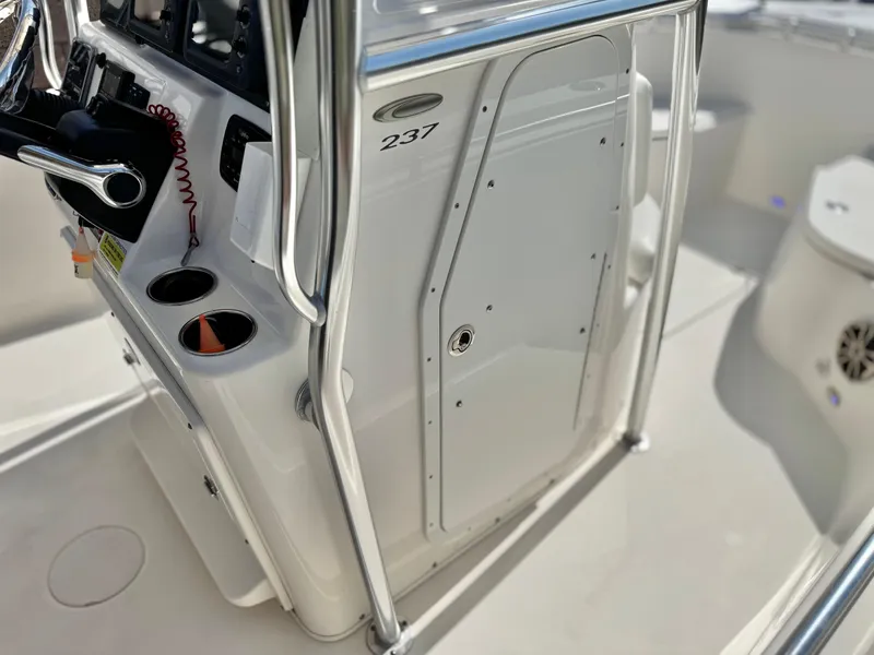 Slide: The Image of 2017 Cobia 237 Center Console boat interior with steering console and storage compartment. - 43