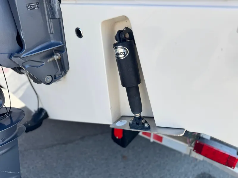 Slide: The Image of 2017 Cobia 237 Center Console boat with trim tab actuator detail. - 8