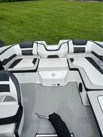 Slide: The Image of 2021 Yamaha Boats AR195, sleek blue and white design, side view. - 10