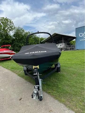 Slide: The Image of 2021 Yamaha AR195 boat with cover on trailer, parked outdoors. - 11